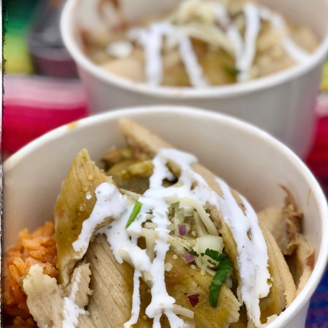 Tamale plate. Tamal. Tamales. Choice of Tamale. Served with cheese sauce, onion, cilantro and  crema on a bed of beans and rice.